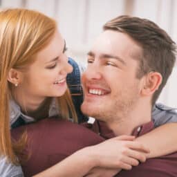 Man wearing hearing aid looking at his girlfriend.