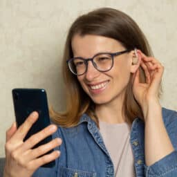 Woman talks on the phone with hearing aids