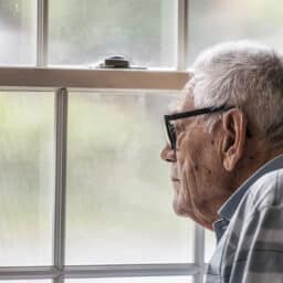 Man stares out window